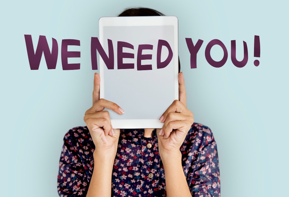 Top 10 Dangerous Emails You Should Never Click On: This photo depicts a woman covering her face with a tablet device displaying the word 