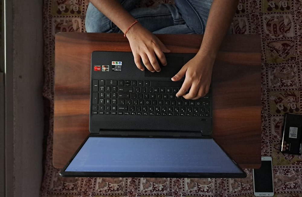 Why Choosing The Right Tech Matters In All Businesses: an individual typing on a laptop