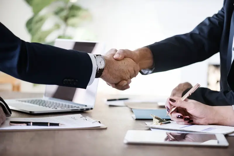 two-person-in-formal-attire-doing-shakehands