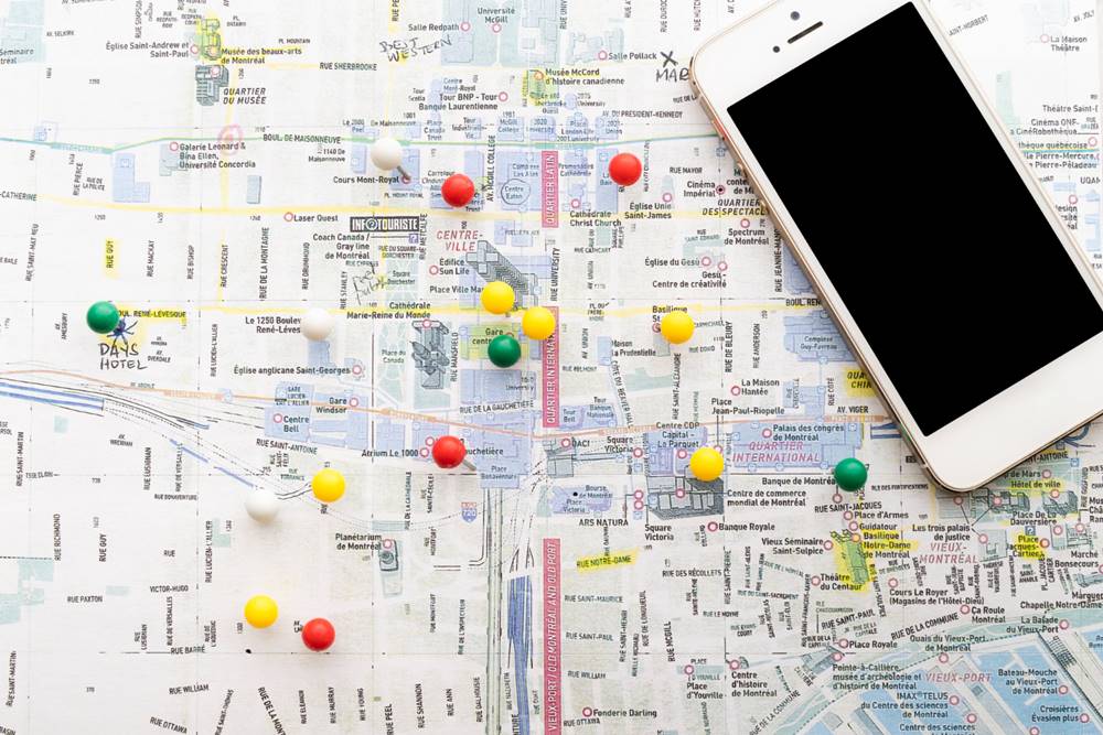 How to Use Relationship Mapping Effectively - This photo shows a marked map with pins and a smartphone.