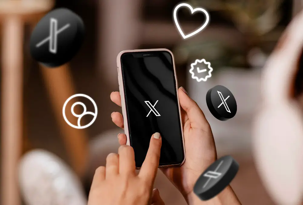 This photo shows a person is holding a smartphone and opening the X (Twitter) mobile app. Numerous X's symbols and icons are floating around the smartphone.