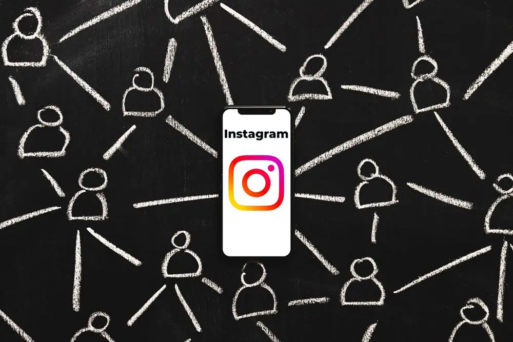 How to leave, delete, or remove someone on Instagram group chat: This image shows a hand drawn figures connected through a smartphone with the Instagram app opened on chalkboard.