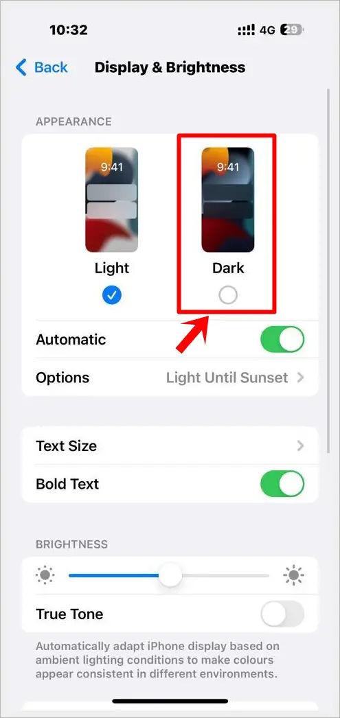 This image shows the "Display & Brightness" screen of an iPhone. The "Dark" option under Appearance is highlighted.