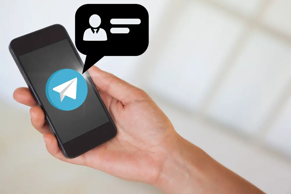 VOIP number for Telegram: This photo depicts a hand holding a smartphone receiving a Telegram message.