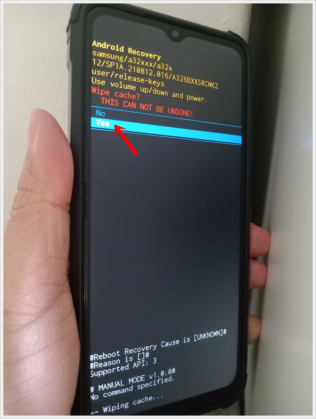 This photo shows a Samsung Galaxy phone displaying the 'Android Recovery' screen with the 'Yes' option highlighted to confirm wipe cache action.