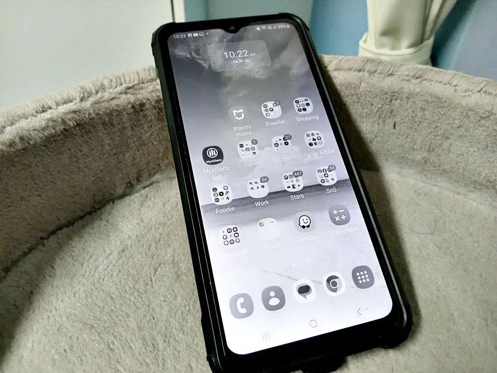 How to Make Your Phone Screen Display in Black and White: This photo captures a smartphone with its screen displaying in black and white, also known as grayscale mode.