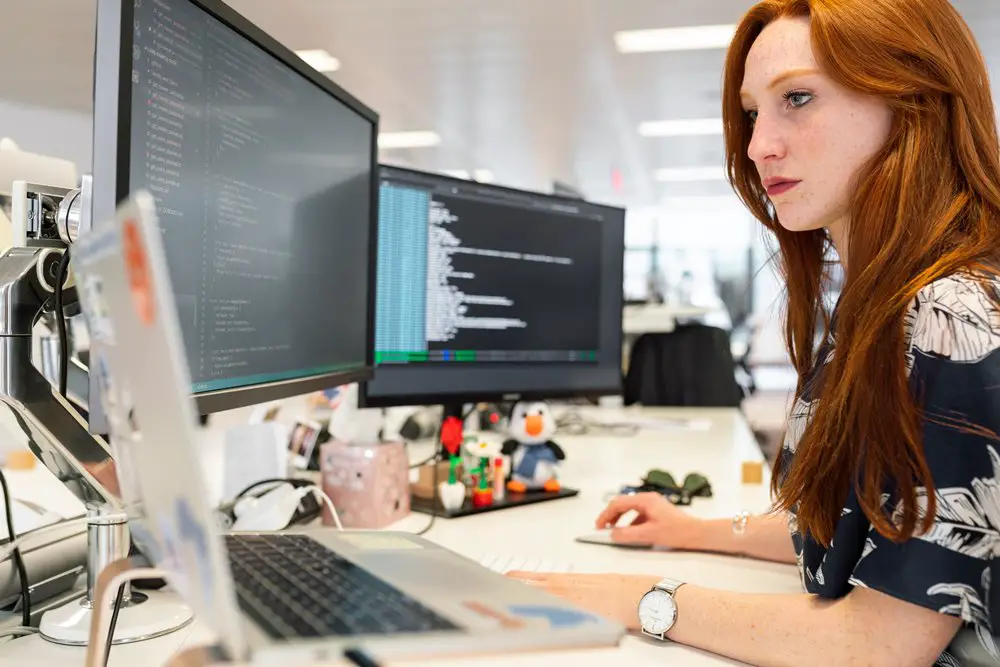 A woman in an office researching professional services automation on her computer