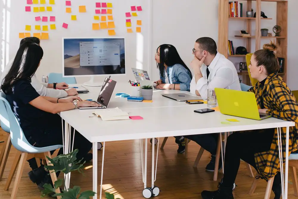 A team in an office discussing professional services automation during a meeting