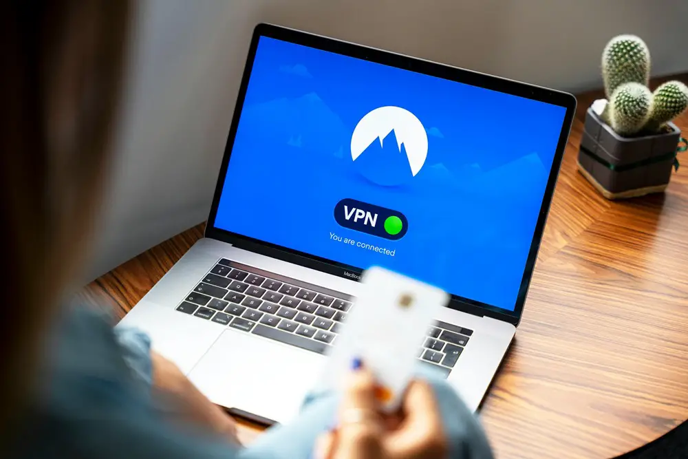 Benefits of Using a VPN: This photo depicts an individual using a VPN service on a laptop.