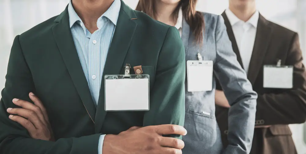 This photo depicts several government officials with badges.