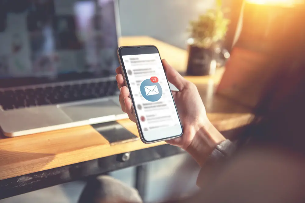 Top 10 Dangerous Emails You Should Never Click On: This photo depicts an individual watching several new emails they just received on their smartphone.