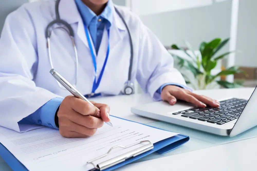 How to Enhance Productivity in Medical Facilities with Technology: This photo depicts a female doctor working with her laptop.