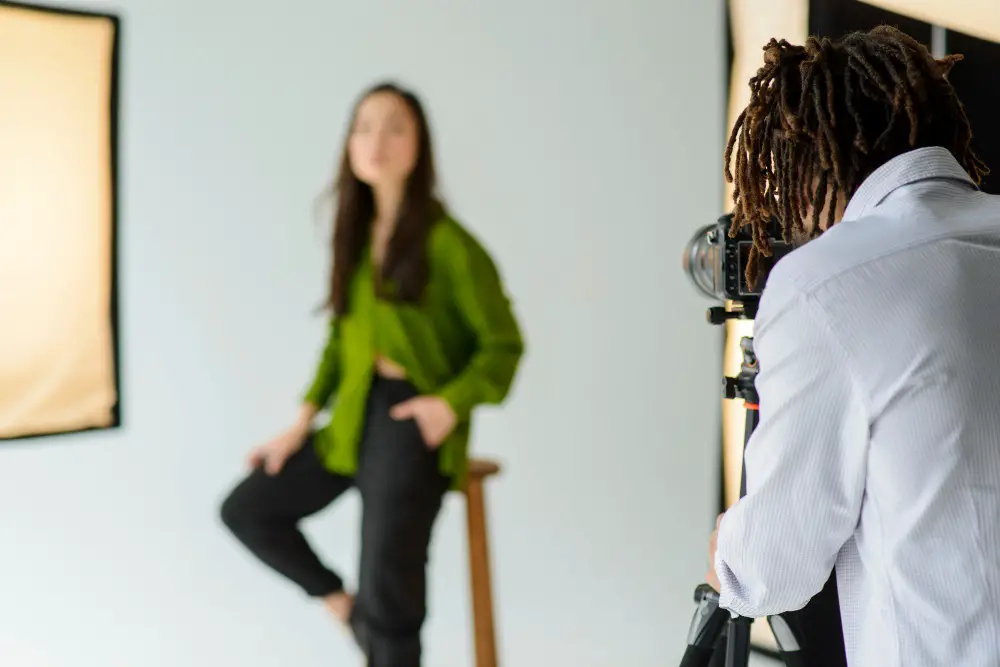 This photo depicts a professional photographer taking headshot photos of a female model.