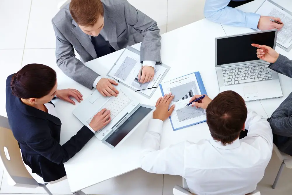 How to Optimize Operations with Managed IT Services: This photo shows a group of IT professionals working in their office.