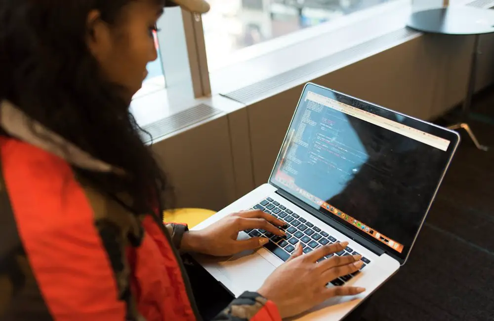 Choosing the right technology for business: Woman Using Macbook Pro