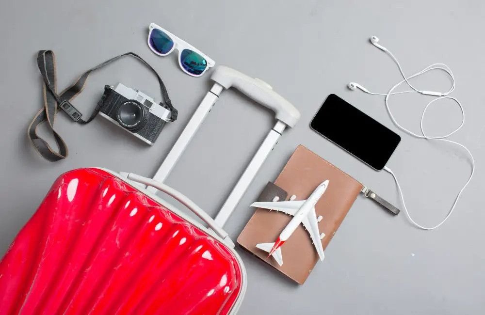Best Travel Hacks for Long Flights: Suitcase with traveler accessories